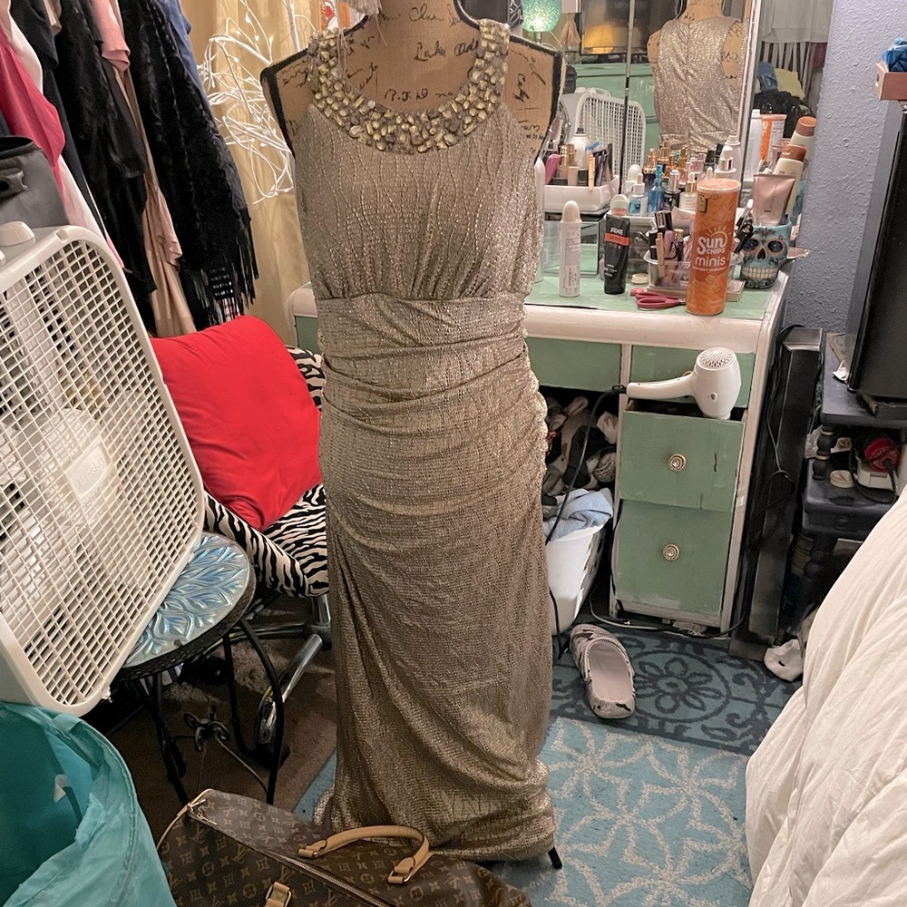 Beautiful purplish shiny long dress w/ a diamond neck.